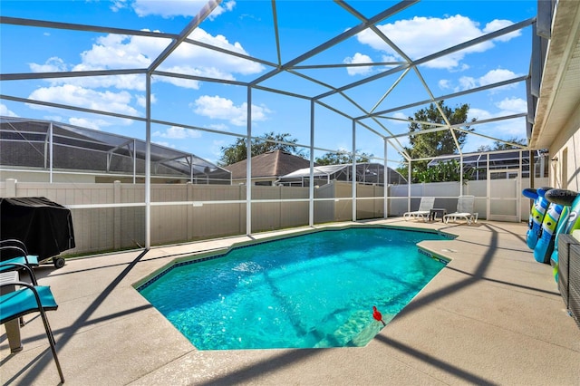 view of swimming pool with a patio and glass enclosure