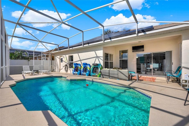 view of pool featuring a lanai, a patio area, and outdoor lounge area