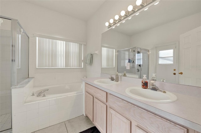 bathroom with tile patterned floors, vanity, and plus walk in shower