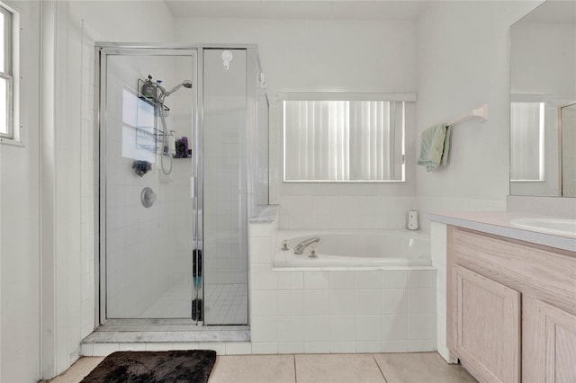 bathroom featuring tile patterned flooring, vanity, and independent shower and bath