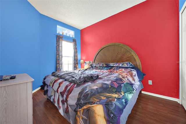 bedroom featuring a textured ceiling, lofted ceiling, and dark wood-type flooring