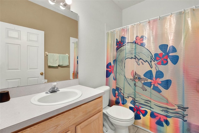 bathroom featuring tile patterned flooring, vanity, and toilet