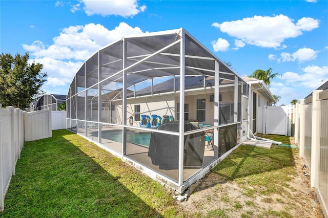 exterior space featuring a lanai, a patio area, a yard, and a fenced in pool