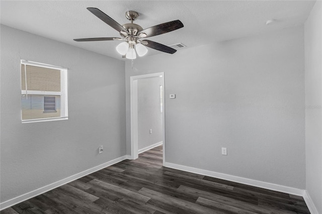 empty room featuring ceiling fan and dark hardwood / wood-style floors