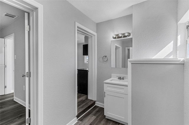 bathroom featuring vanity and hardwood / wood-style flooring