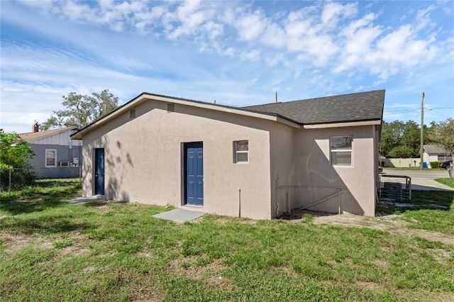 back of property featuring a yard