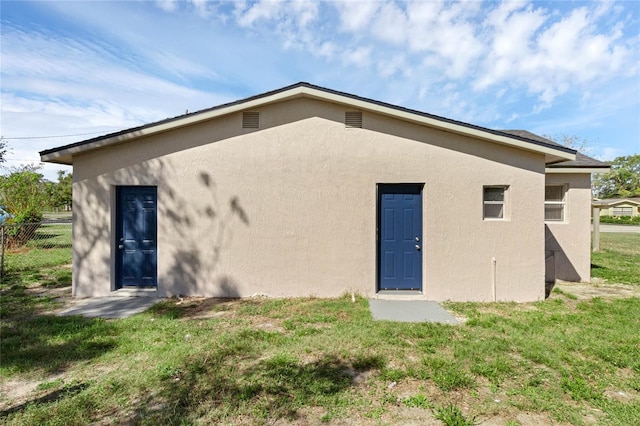 rear view of property featuring a yard