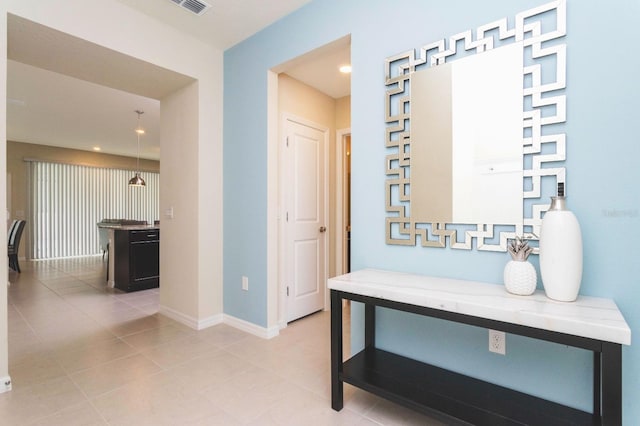 hall with light tile patterned flooring