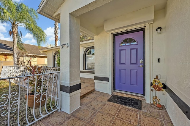 entrance to property featuring a porch