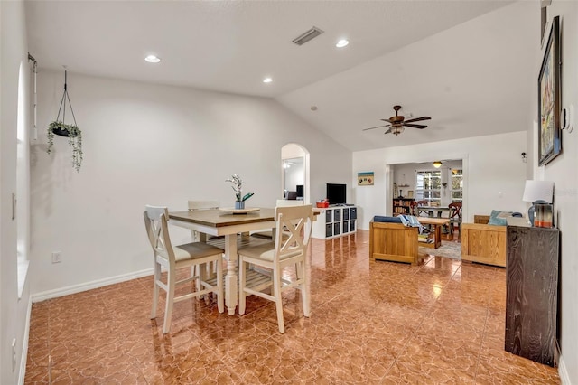 dining area with ceiling fan and vaulted ceiling