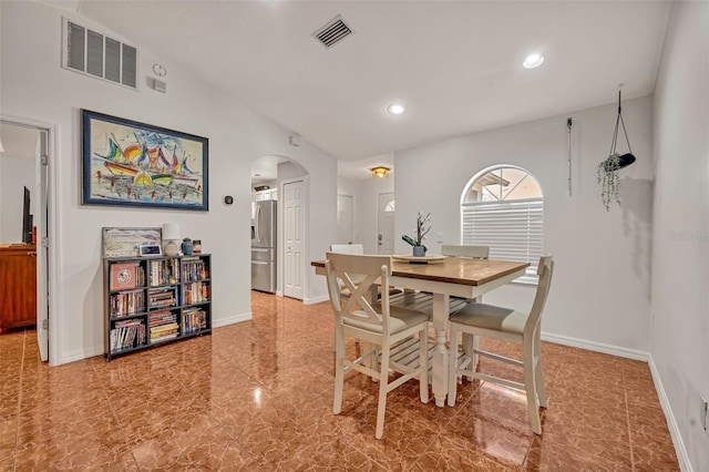 dining space featuring lofted ceiling