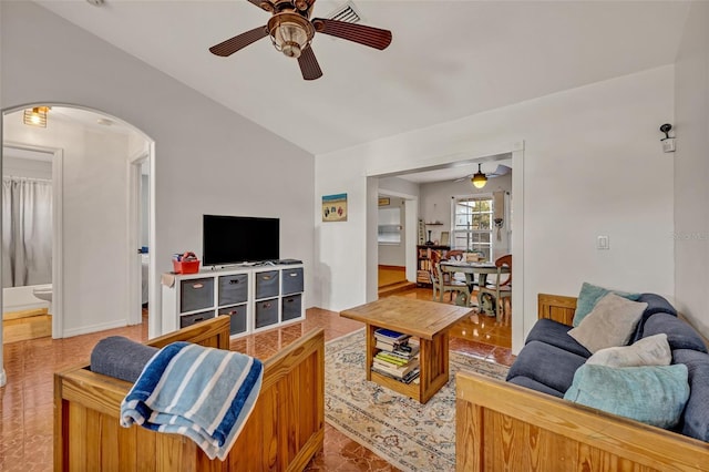 living room featuring ceiling fan and vaulted ceiling