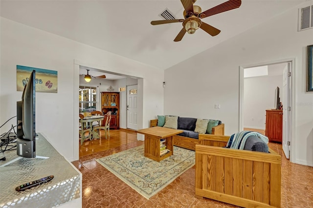 living room featuring ceiling fan and vaulted ceiling