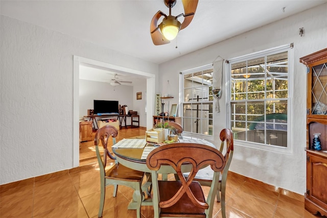 dining room with ceiling fan and light tile patterned floors