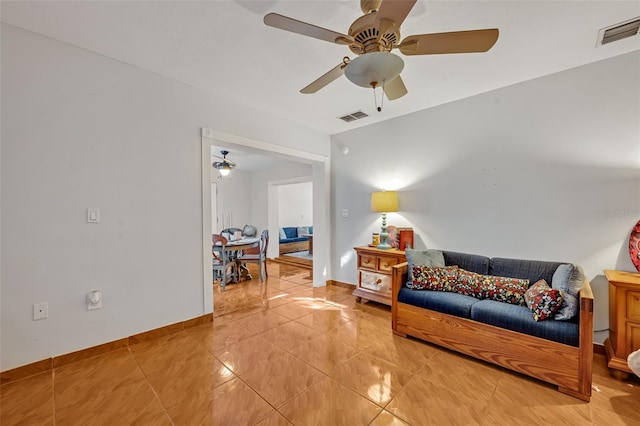 sitting room featuring ceiling fan and tile patterned flooring