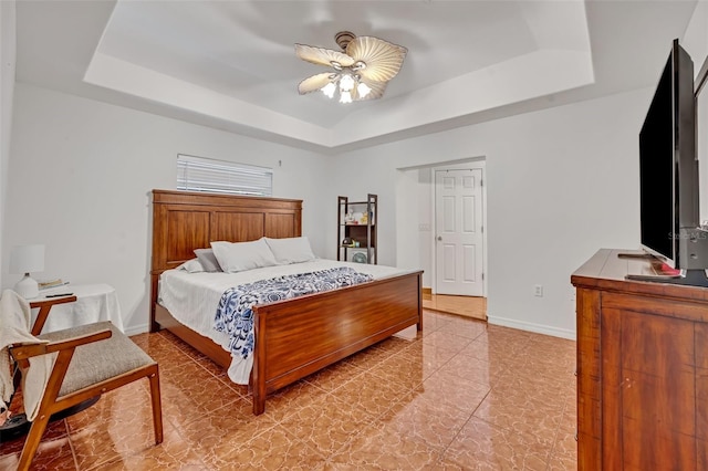 bedroom featuring a tray ceiling and ceiling fan