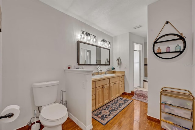 bathroom with tile patterned floors, vanity, and toilet