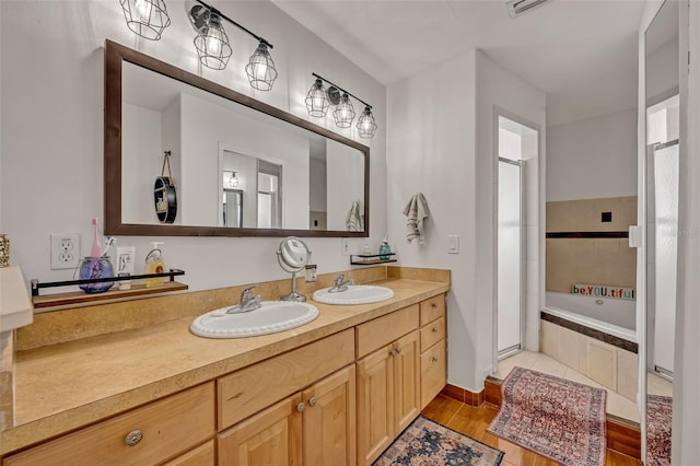 bathroom featuring vanity, plus walk in shower, and wood-type flooring