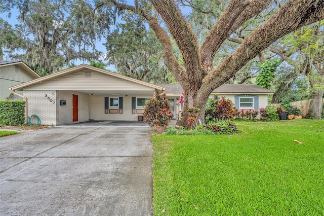 single story home featuring a front lawn and a carport