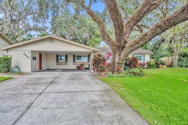 ranch-style house with a front yard and a carport