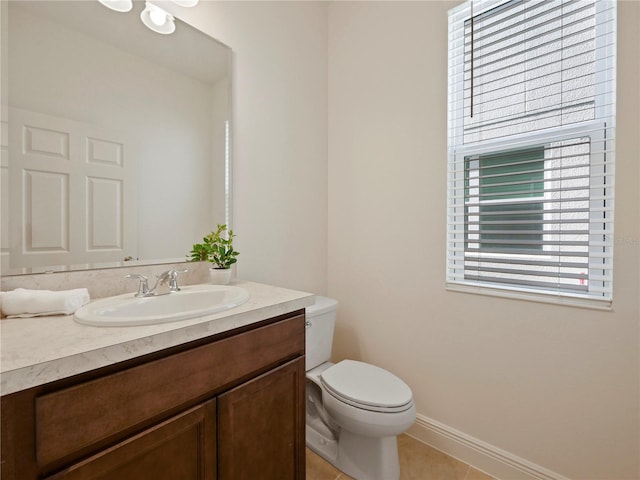 bathroom featuring tile patterned floors, vanity, and toilet