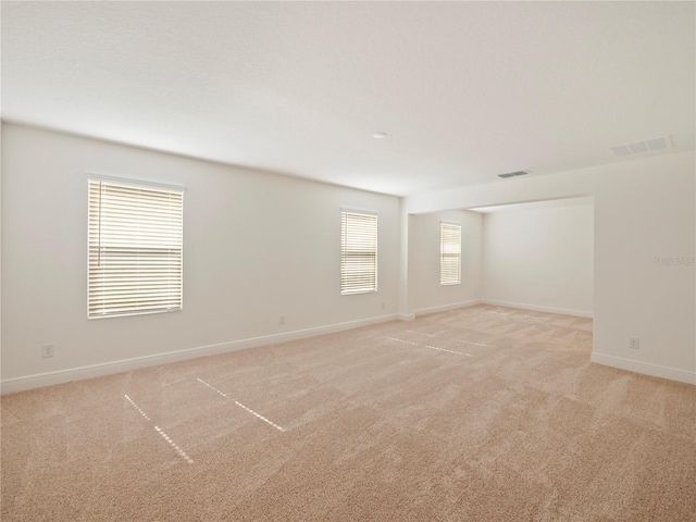 unfurnished room featuring light colored carpet