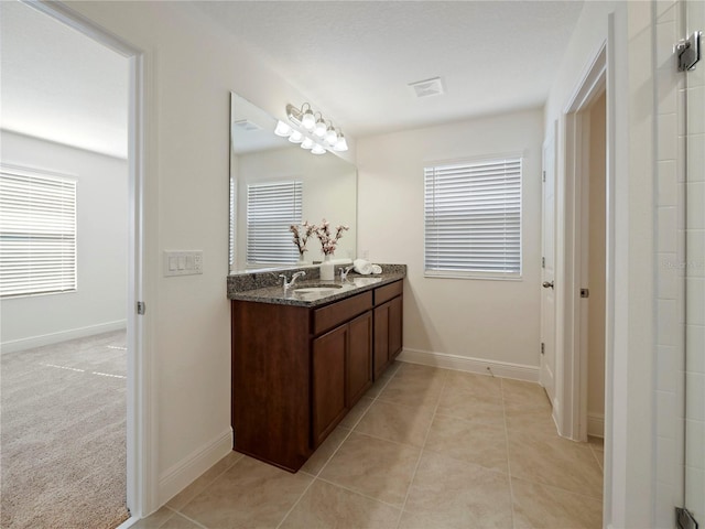 bathroom featuring tile patterned floors, plenty of natural light, and vanity