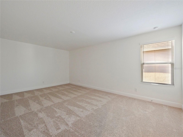 empty room with light colored carpet