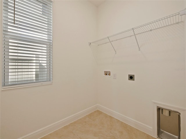 laundry room featuring hookup for an electric dryer, light tile patterned floors, and hookup for a washing machine