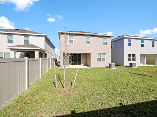 rear view of house featuring central AC, a patio area, and a lawn