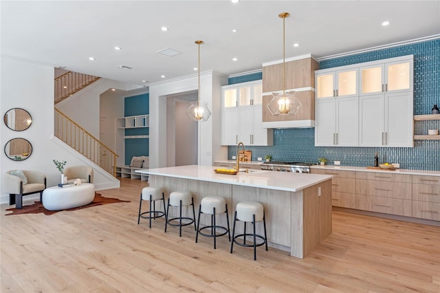 kitchen with light countertops, glass insert cabinets, and white cabinets