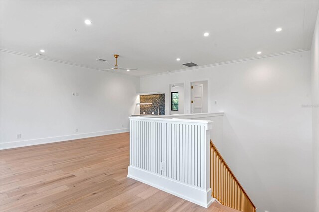 empty room with recessed lighting, a ceiling fan, visible vents, light wood-type flooring, and crown molding