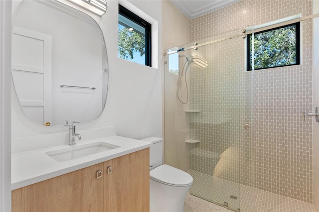 bathroom with tiled shower, plenty of natural light, and toilet