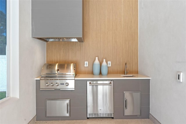 interior space featuring light speckled floor, refrigerator, and a sink