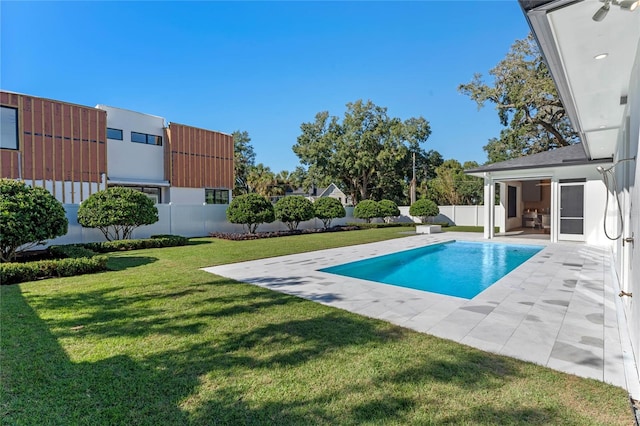 view of pool featuring a patio, a lawn, fence, and a fenced in pool