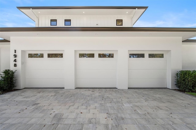 garage with decorative driveway