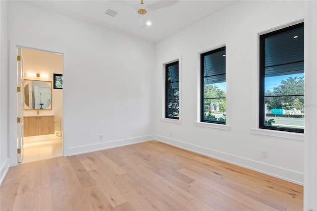 unfurnished room with light wood-style floors, recessed lighting, visible vents, and baseboards