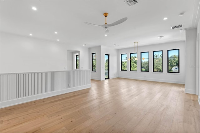 spare room with recessed lighting, visible vents, light wood-style flooring, a ceiling fan, and baseboards