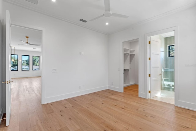 spare room with light wood finished floors, ceiling fan, and baseboards