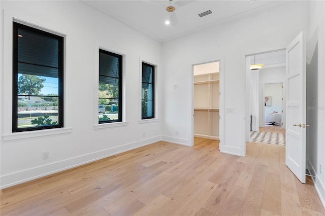 spare room with light wood-style floors, recessed lighting, visible vents, and baseboards