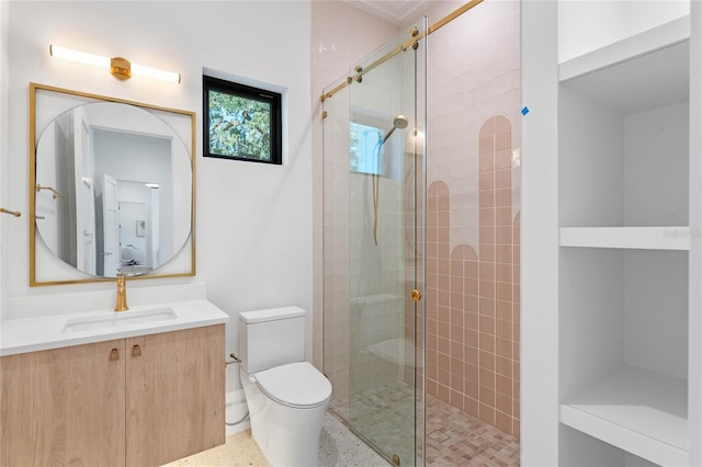 full bath featuring toilet, a shower stall, speckled floor, and vanity