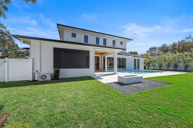 back of house with a fenced in pool, a yard, a patio, board and batten siding, and a fenced backyard