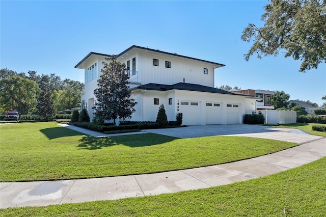 view of front of house with a front lawn and a garage