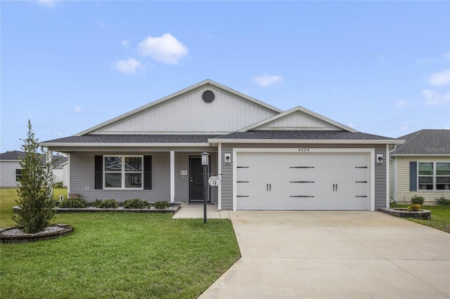 single story home with a garage and a front lawn