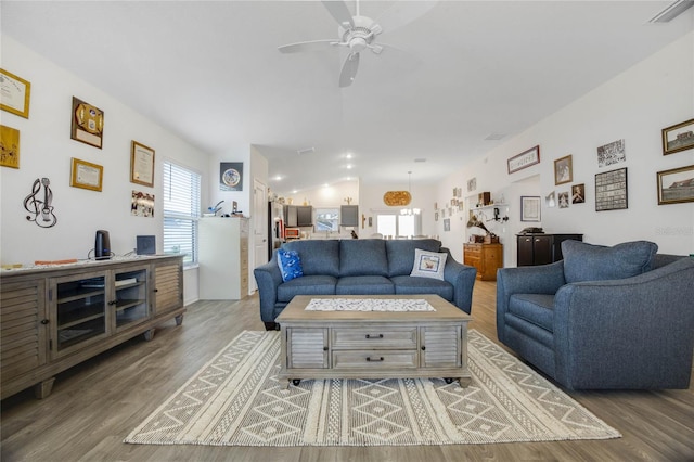 living room with hardwood / wood-style floors and ceiling fan