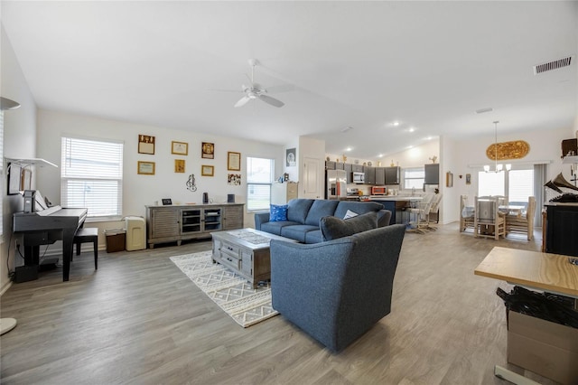 living room with ceiling fan, light wood-type flooring, and a wealth of natural light