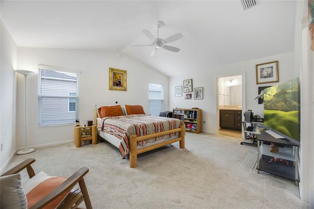 bedroom with connected bathroom, ceiling fan, light colored carpet, and lofted ceiling