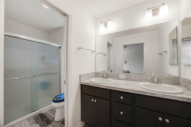 bathroom with vanity, hardwood / wood-style flooring, toilet, and walk in shower