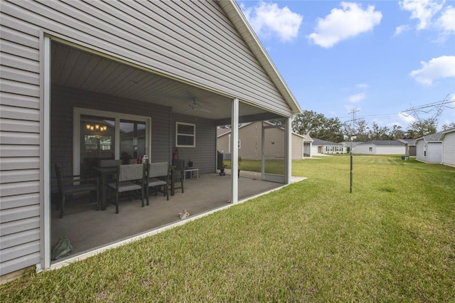 view of yard featuring ceiling fan and a patio