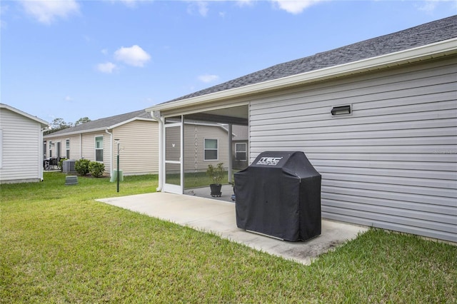 back of house featuring a lawn, central AC, and a patio